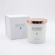 Aurean Golden Lumos scented candle with its premium white magnetic gift box featuring the protective Evil Eye brand mark.